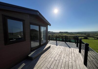 Sun beating down on lodge decking Pennant Igyn Holiday Cottage